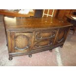 A REDUCED HEIGHT ANTIQUE OAK SIDEBOARD