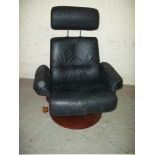 A BLACK LEATHER SWIVEL RECLINER CHAIR