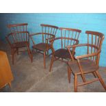 FOUR STICK BACK CARVER CHAIRS IN ERCOL STYLE, (SLIGHTLY DOGGY CHEWED)