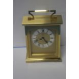 AN ANGELUS BRASS CLOCK