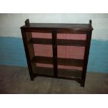 AN OAK ANTIQUE GLAZED LOCKING BOOKCASE