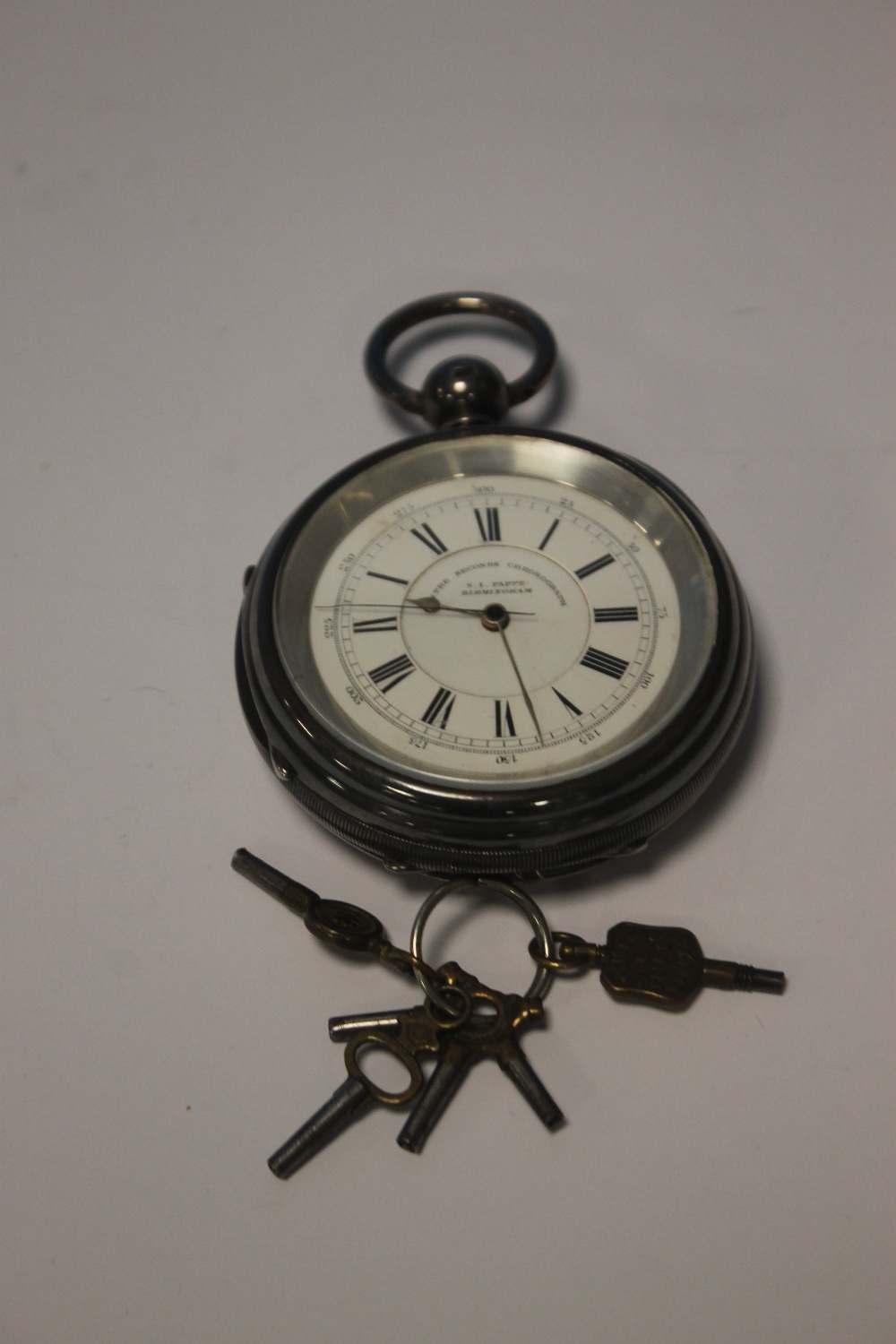 AN OVER SIZED OPEN FACE POCKET WATCH SIGNED TO THE DIAL AND MOVEMENT AND A QUANTITY OF WATCH KEYS