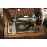 A CASED SINGER SEWING MACHINE`