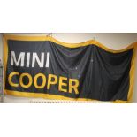 A MINI COOPER ORIGINAL DEALERS SHOWROOM BANNER, in gold, black and white, approx. 145 x 350 cm
