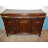 AN ANTIQUE WALNUT SIDEBOARD WITH CARVED DETAIL