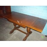 A VINTAGE OAK DRAW LEAF TABLE WITH PINEAPPLE STYLE LEGS