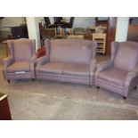 A FABRIC TWO SEATER THREE PIECE SUITE WITH BRASS CASTORS