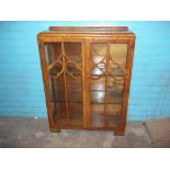 A VINTAGE DISPLAY CABINET IN WALNUT