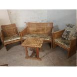 AN OAK MODERN LATTICE STYLE GARDEN SUITE COMPRISING TWO SEATER, TWO CHAIRS AND A TABLE