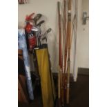 THREE VINTAGE FISHING RODS together with a collection of golf clubs