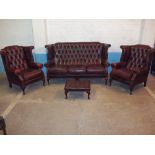 A HIGH WING BACKED LEATHER OXBLOOD FOUR PIECE CHESTERFIELD SUITE WITH QUEEN ANNE STYLE LEGS,