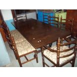 A LARGE EXTENDING OAK DINING TABLE WITH TEN CHAIRS