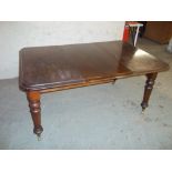 A VICTORIAN EXTENDING WIND-OUT DINING TABLE WITH ONE LEAF