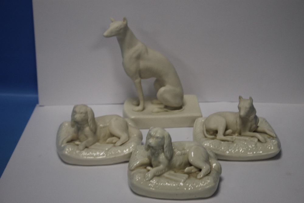 THREE BELLEEK SEATED DOGS TOGETHER WITH ANOTHER ALL WITH GREEN MARKS TO BASE