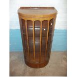 A BOWED WALNUT VINTAGE DISPLAY CABINET