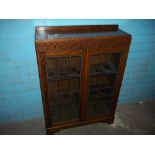 AN OAK LEADED VINTAGE BOOKCASE