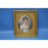 A 19TH CENTURY MINIATURE PORTRAIT OF A YOUNG LADY IN A GILT METAL FRAME, INSCRIBED TO THE BACK "