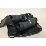 A PAIR OF PENTAX 1650 PCF BINOCULARS IN A LEATHERETTE CARRY CASE