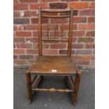 AN ANTIQUE OAK CHAIR WITH RAILS