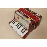 A SMALL NOVELTY BONTEMPI ACCORDION