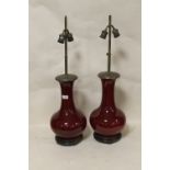 AN UNUSUAL PAIR OF ORIENTAL CERAMIC SANG DE BEOUF TWIN BULB LAMPS