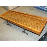 A WOODEN TABLE TOP SERVING TRAY ON METAL LEGS