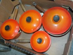 A SET OF FOUR GRADUATED LE CREUSET LIDDED COOKING PANS TOGETHER WITH A CERAMIC BREAD BIN