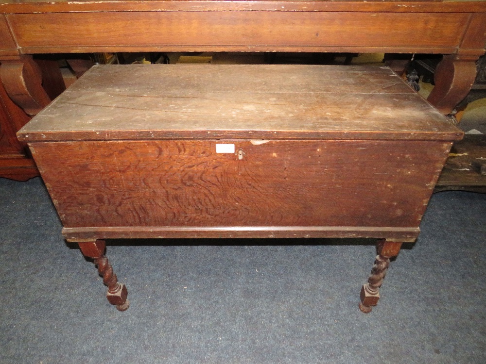 AN ANTIQUE OAK BLANKET BOX RAISED ON A BARLEYTWIST STAND W-94 CM