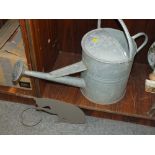 A VINTAGE GALVANISED WATERING CAN TOGETHER WITH A CAT DESIGN PLANT POT HOLDER (2)