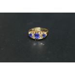 A HALLMARKED 18 CARAT GOLD SAPPHIRE AND DIAMOND RING - BIRMINGHAM 1910, set with three nicely