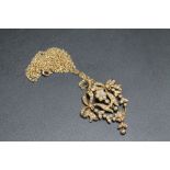 AN ANTIQUE TYPE 15CT GOLD SEED PEARL ARTICULATED PENDANT, in a bow and flower design and on