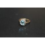 A HALLMARKED 9 CARAT GOLD AQUA MARINE TYPE RING, with diamond accent surround, approx weight 2g,