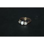 AN OPAL AND DIAMOND THREE STONE RING, marks indistinct, approx weight 3g, ring size N 1/2