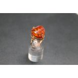 AN UNUSUAL RUSSIAN AMBER RING, with small pretty petal type inclusions and set in Russian hallmarked