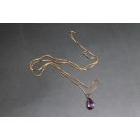 A TEARDROP AMETHYST PENDANT, mount stamped 18k - not tested, on yellow metal chain, amethyst H 2 cm