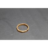 A HALLMARKED 22 CARAT GOLD BAND, split, approx weight 2.2g