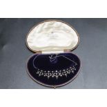 A DIAMOND AND SEED PEARL ANTIQUE NECKLACE, in fitted case.