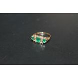 A HALLMARKED 9 CARAT GOLD THREE STONE EMERALD AND DIAMOND RING, approx weight 2.5g, ring size L
