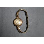 A VINTAGE HALLMARKED 9 CARAT GOLD WRIST WATCH, on expanding plated bracelet, Dia 2.5 cm