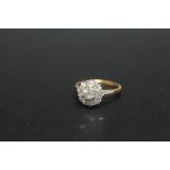 AN 18CT AND PLATINUM DIAMOND CLUSTER RING, set with nine diamonds totalling an estimated 1 carat,