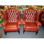 A PAIR OF OXBLOOD LEATHER WINGBACK ARMCHAIRS