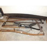 A SELECTION OF VINTAGE FARMING AND GARDENING IMPLEMENTS TO INCLUDE TWO CROSS BANDED SAWS