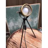 A HEAVY BRASS CARBIDE TABLE LAMP MOUNTED ON A LATER BLACK PAINTED TRIPOD STAND