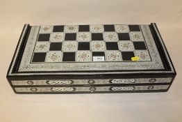 AN INDIAN STYLE HEAVILY INLAID GAMES BOARD AND COUNTERS
