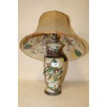 AN ORIENTAL TABLE LAMP WITH A DECORATIVE SHADE