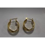 A PAIR OF YELLOW METAL HOOP EARRINGS