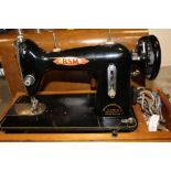 A CASED VINTAGE BSM ELECTRIC SEWING MACHINE
