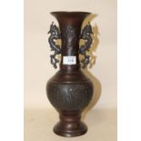 A MODERN ORIENTAL BRONZE EFFECT VASE WITH DRAGON SHAPED HANDLES