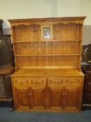 A MODERN PINE KITCHEN DRESSER WITH LEADED STAINED GLASS DETAIL H-203 W-155 CM