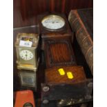 A VINTAGE BRASS CARRIAGE CLOCK, MISSING SIDE PANEL, TOGETHER WITH A CARVED OAK MINIATURE LONG CASE